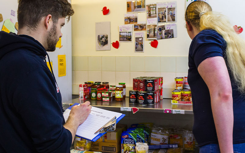 a photo of student staff taking inventory in the pantry