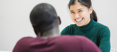 staff member with a smile talking to a student